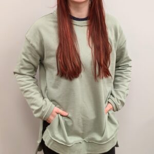 women with long red hair modeling light green sweatshirt