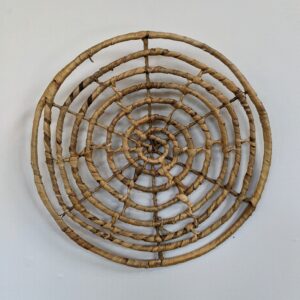 Woven water hyacinth wall hanging designed in a spiral