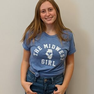 women modeling medium blue t shirt with the words The Midwest Girl and map of Illinois in white