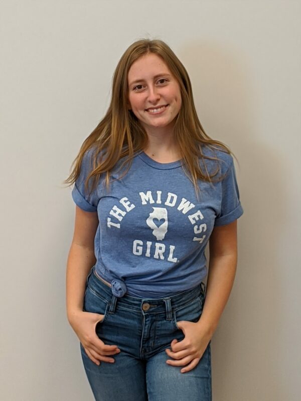 women modeling medium blue t shirt with the words The Midwest Girl and map of Illinois in white
