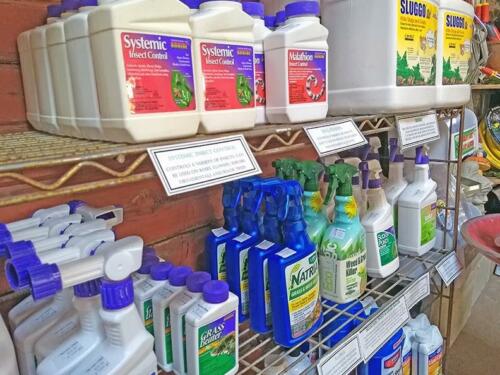 Insect control, weed killer, and other sprays and plant care products displayed on merchandise shelf