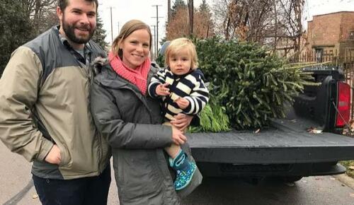 Family stands next to an open truck showing the Christmas tree they found at Blumen Gardens tree farm 